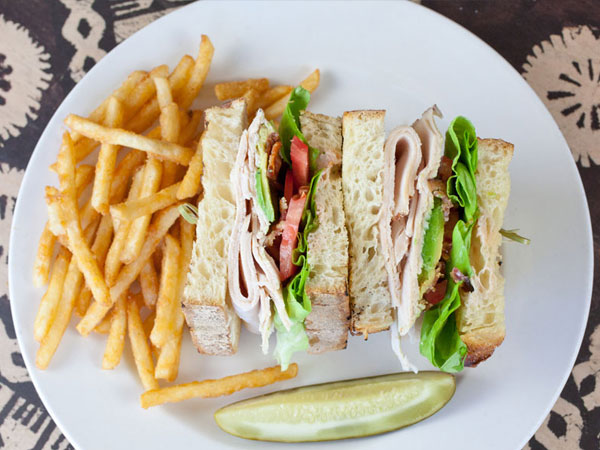 Turkey sandwich with fries and a pickle