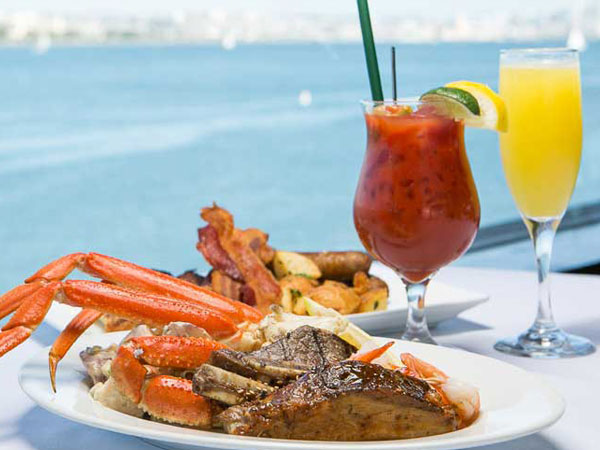 Steak and Lobster with various drinks and a view of the ocean