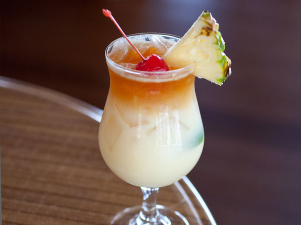 Tropical drink with a pineapple and cherry