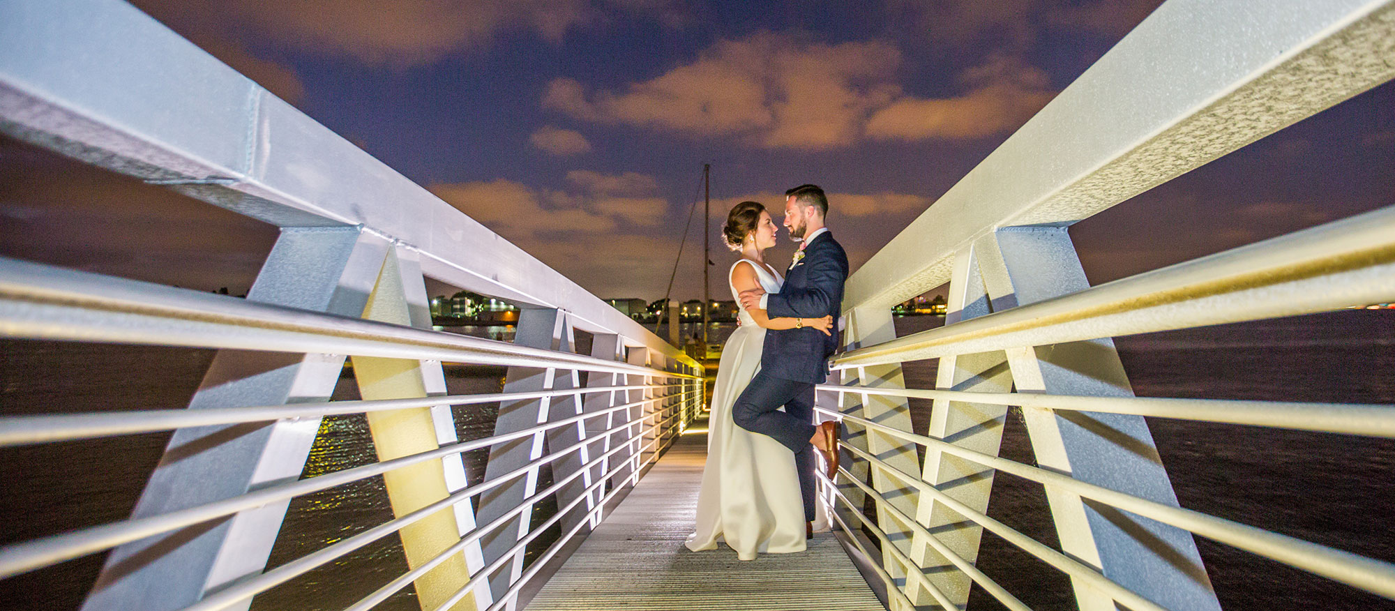 A happy couple standing on a dock