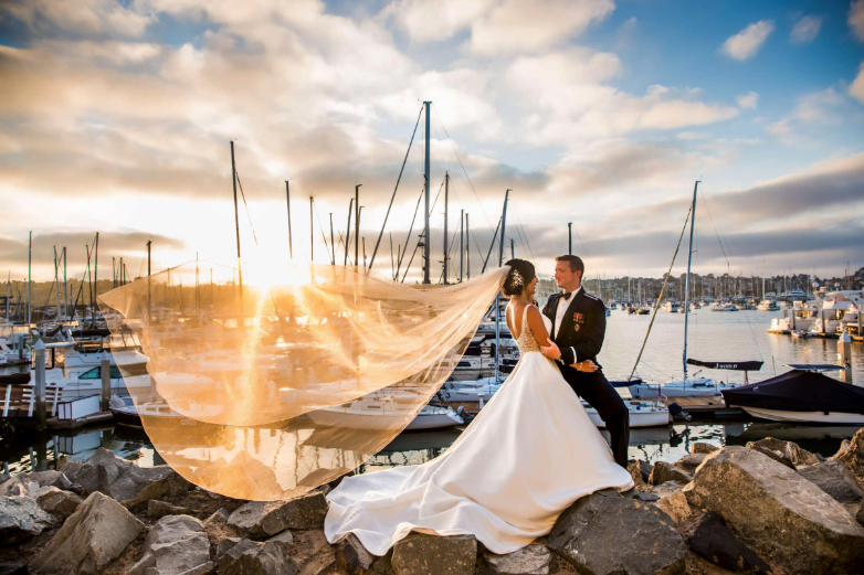 Couple near the water with boats