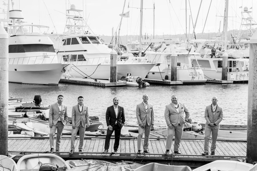 men on a dock in front of boats