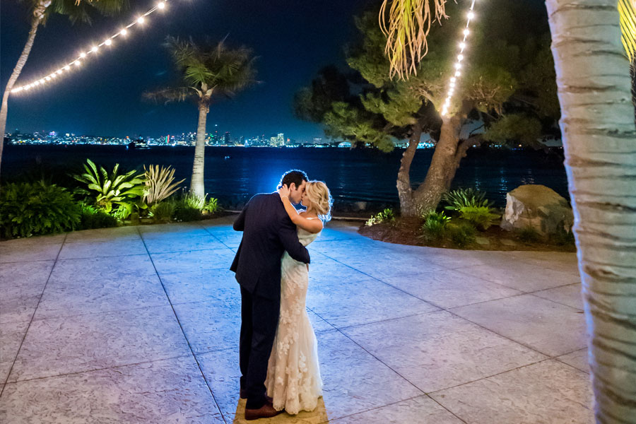 a couple dancing near the water