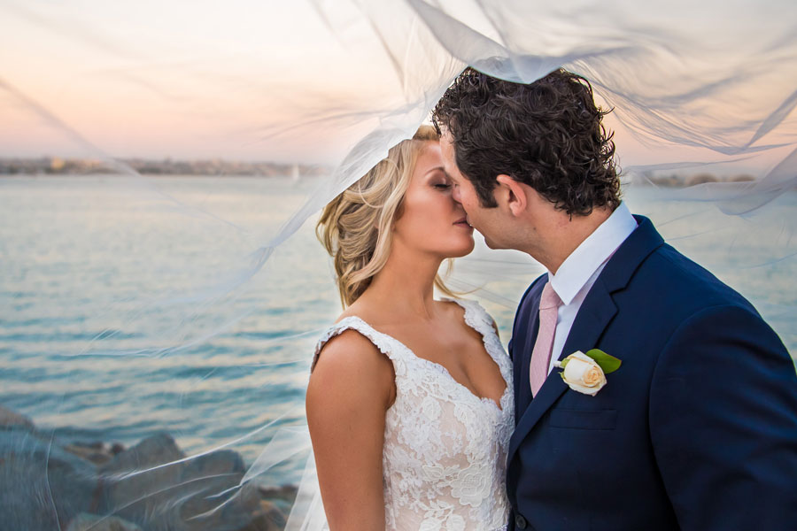 A happy couple kissing near the water