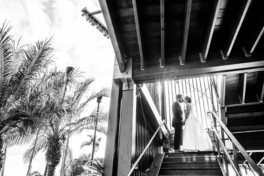 A happy couple walking out of Bali Hai after their wedding