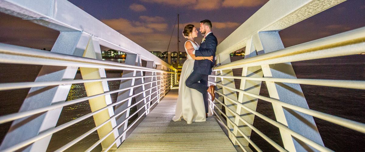 A married couple on a dock to the water