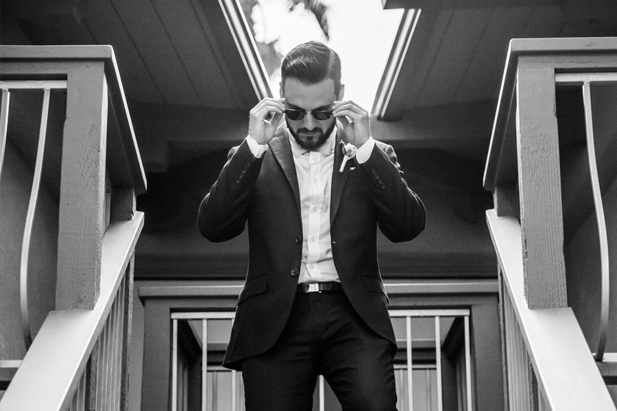 The groom walking down the stairs